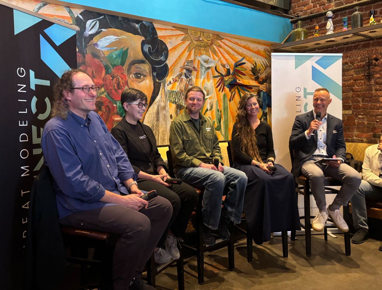 A candid shot of panel members at TMC